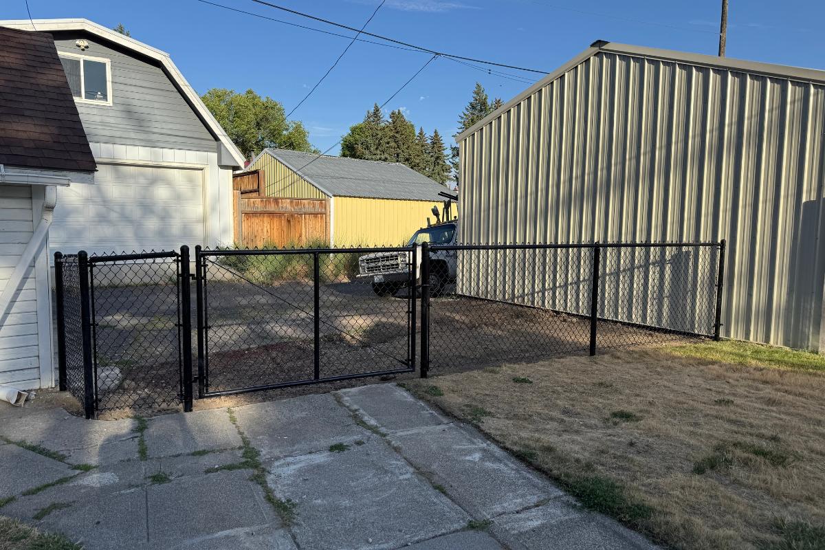 black chain link fence with a gate built in spokane washington by robertson fence